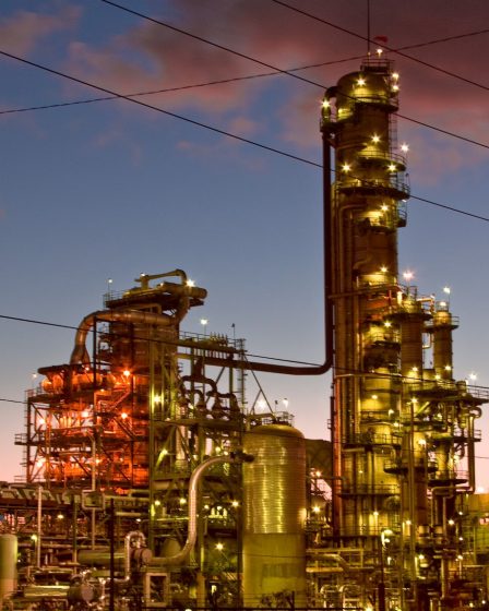 A picture of an oil refinery, taken either at dawn or dusk.